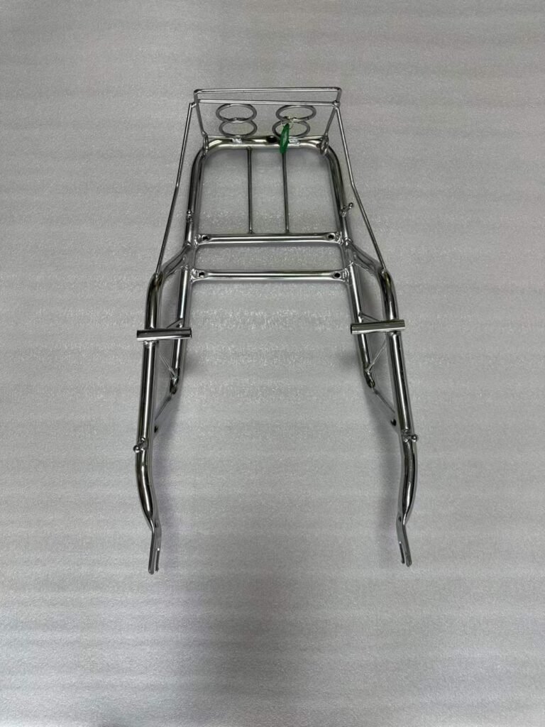 Finished plated motorcycle rear rack on a neutral background for surface inspection