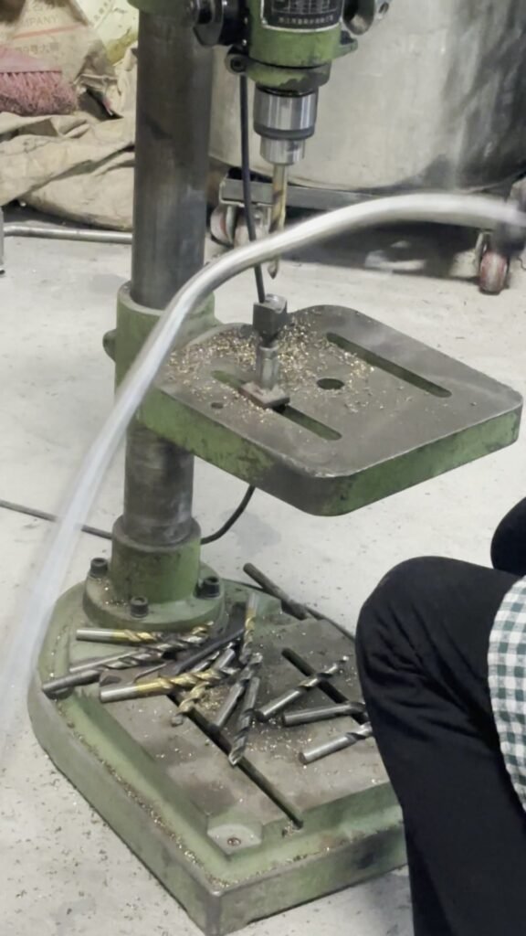 Drilling a mounting hole in a tubular motorcycle part