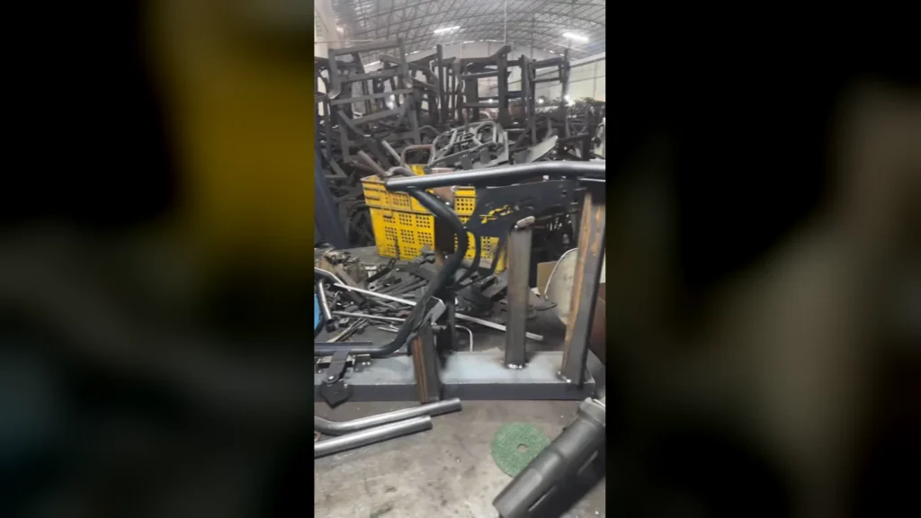PCX160 crash bar welding fixtures in a motorcycle parts workshop